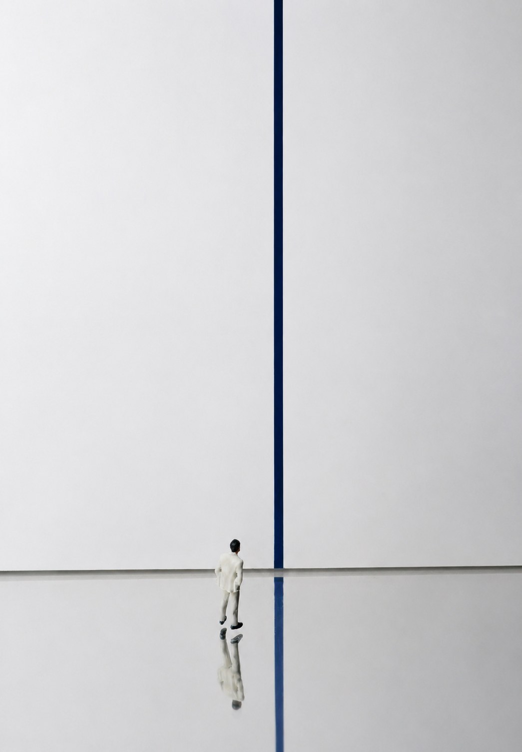 SUIT-MAN standing at a threshold